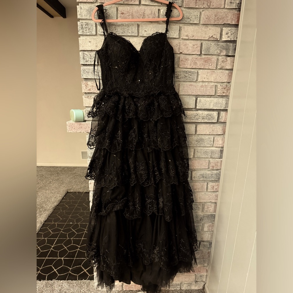 have a slit in the right leg. was altered to have a lace up back. JJs house.